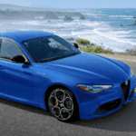 Blue 2022 Alfa Romeo Giulia drives along the ocean