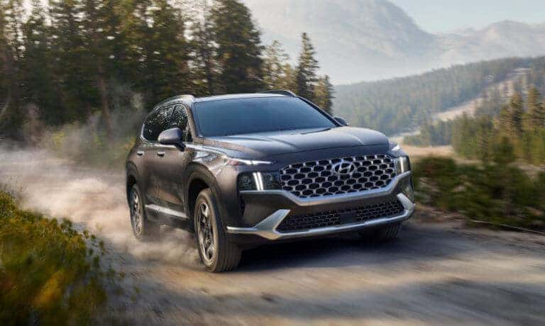2022 Hyundai Santa Fe driving on a dusty mountain road