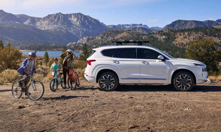 2022 Hyundai Santa Fe parked by a trail with some cyclists