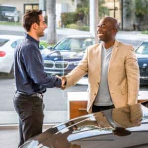 Two men shaking hands at Dealership.
