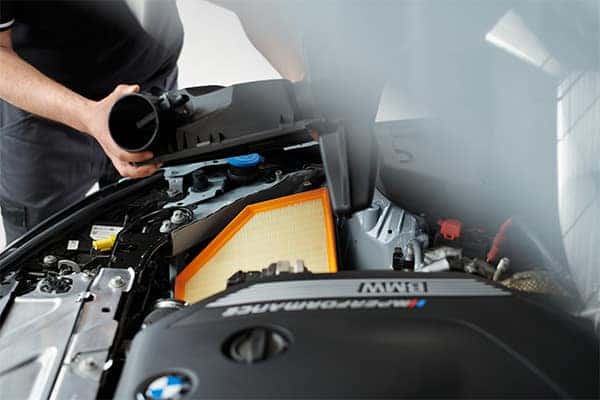 BMW service technician performing maintenance