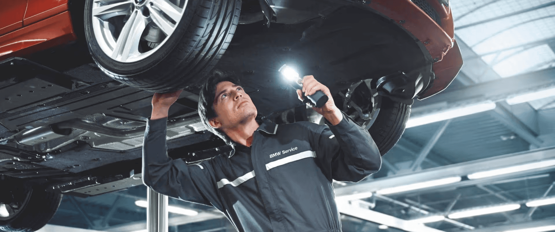 BMW technician inspecting vehicle