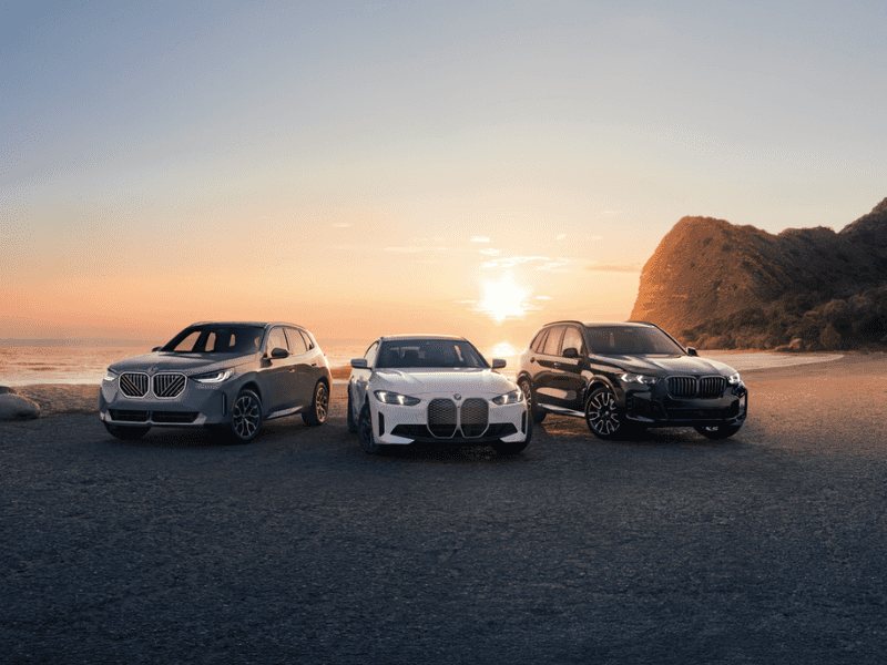 BMW SUVs and sedans parked at sunset