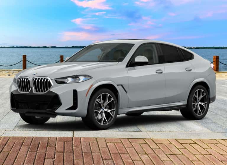 Gray BMW X6 shown from a front three-quarter view near the waterfront.