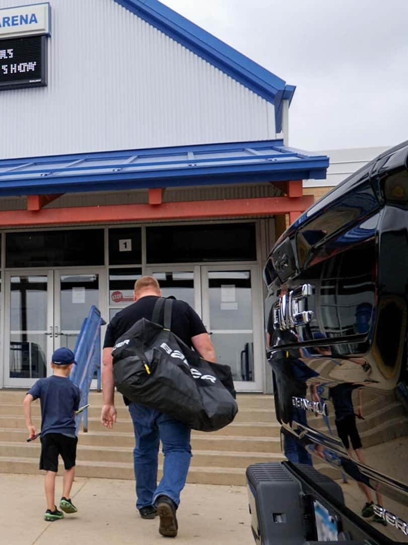father and son walking into hockey practice
