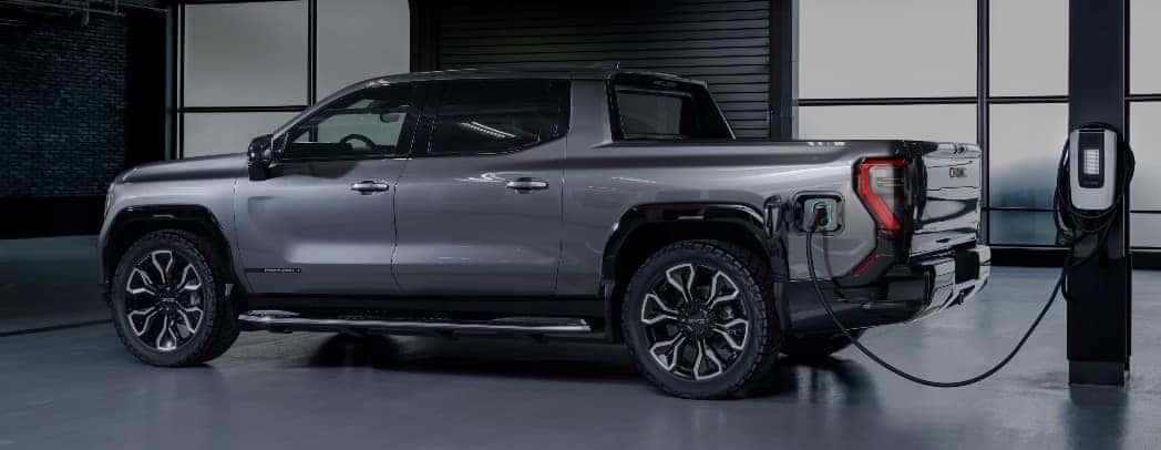 2024 GMC Sierra EV Denali Edition 1 Exterior Driver Side Rear Profile while Charging_o
