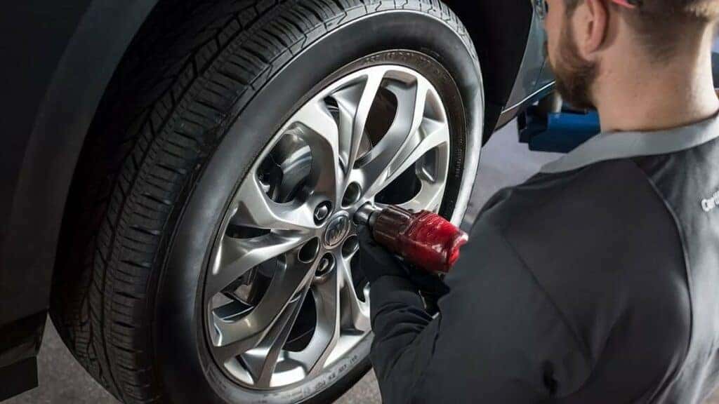 Buick GMC Service Professional Performing a Tire Change on a Buick