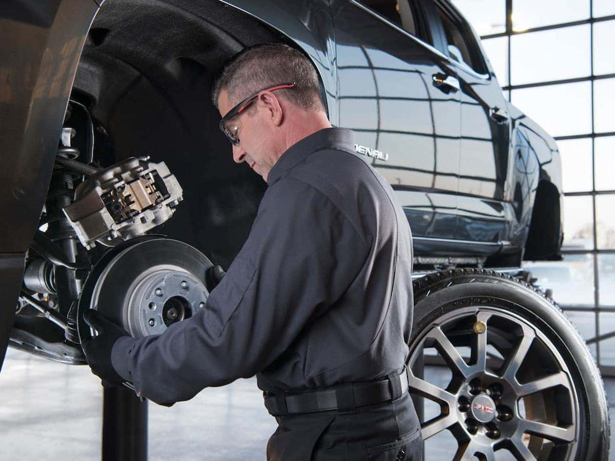 Buick GMC Service Professional Performing a Tire Change on a GMC