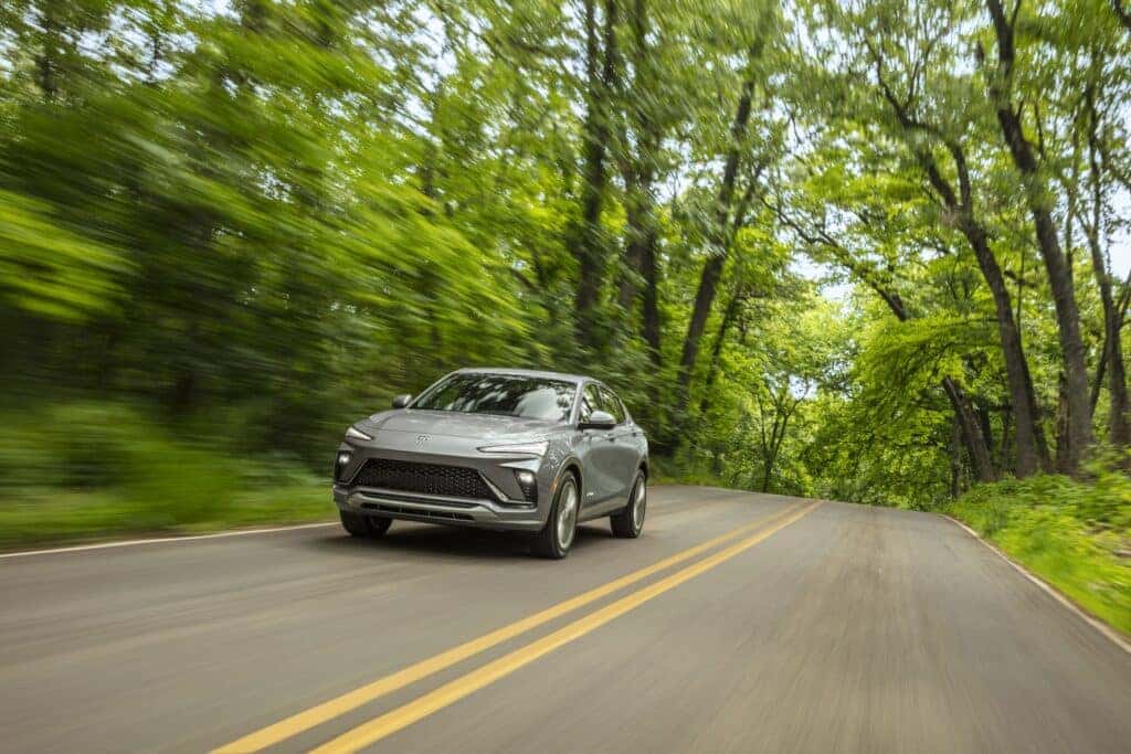 Front 3/4 view of the 2024 Buick Envista Avenir in Moonstone Gray Metallic on the road. Preproduction model shown. Actual production model may vary. Arriving summer 2023.