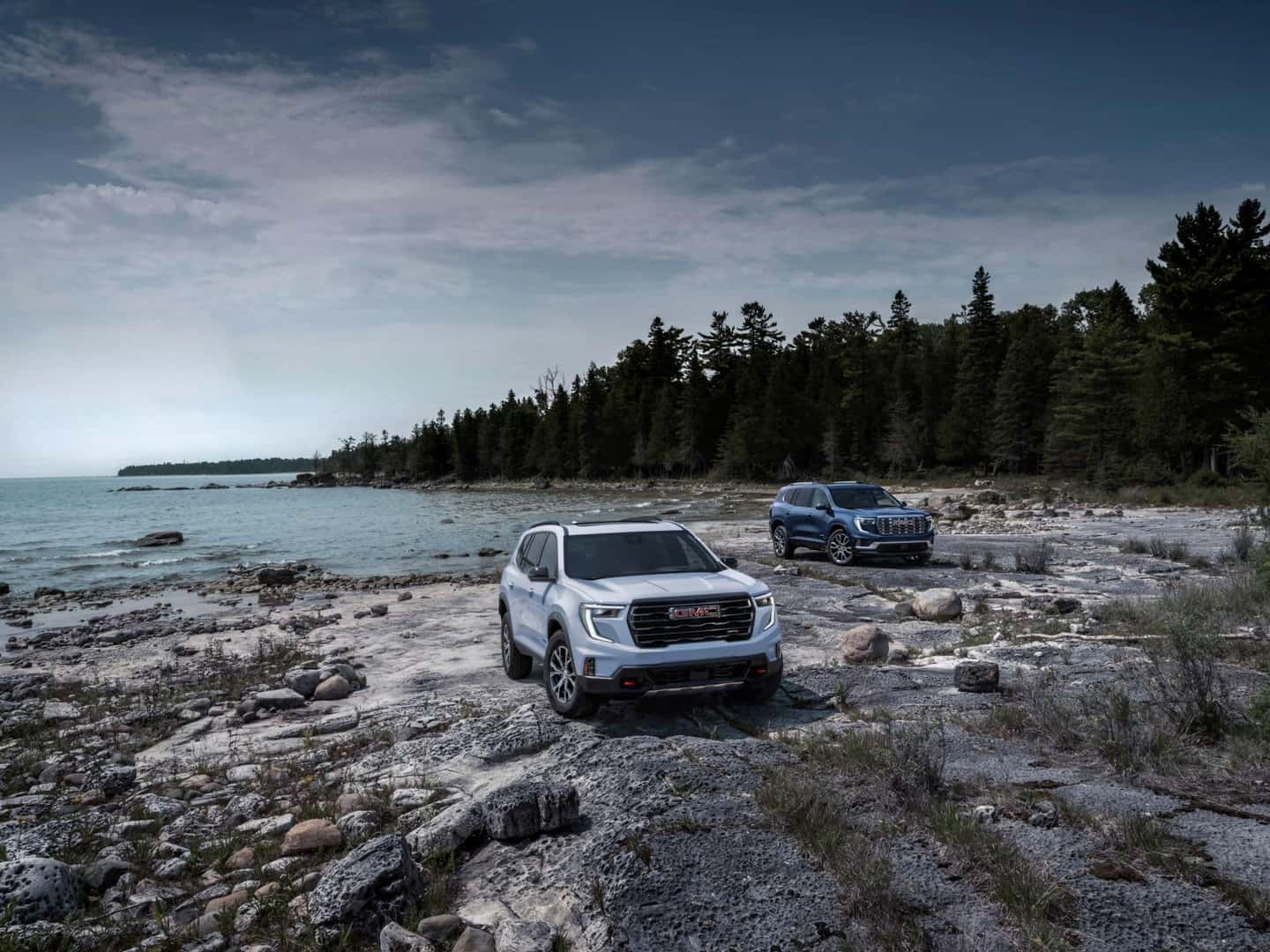 Overhead Shot Of Two 2024 GMC Acadia AT4 Denalis, On A Cold Coast