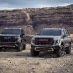 Pack view of the 2025 GMC Yukon, including the AT4 Ultimate (right) and Denali Ultimate (left).