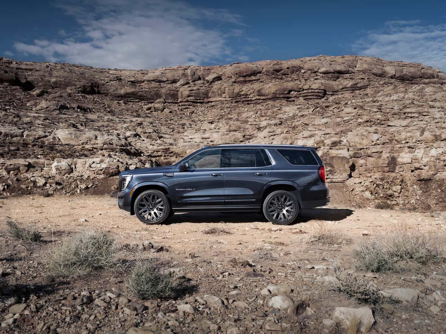 Wide angle side profile view of the 2025 GMC Yukon Denali Ultimate.
