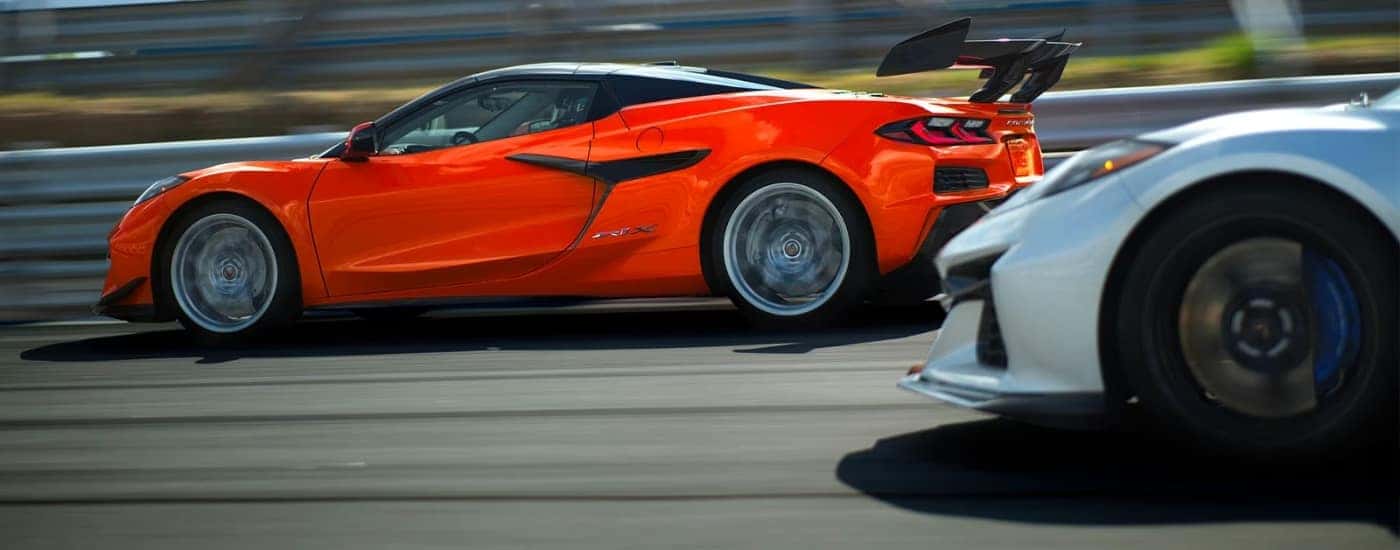 An orange and a silver 2026 Chevy Corvette ZR1X racing