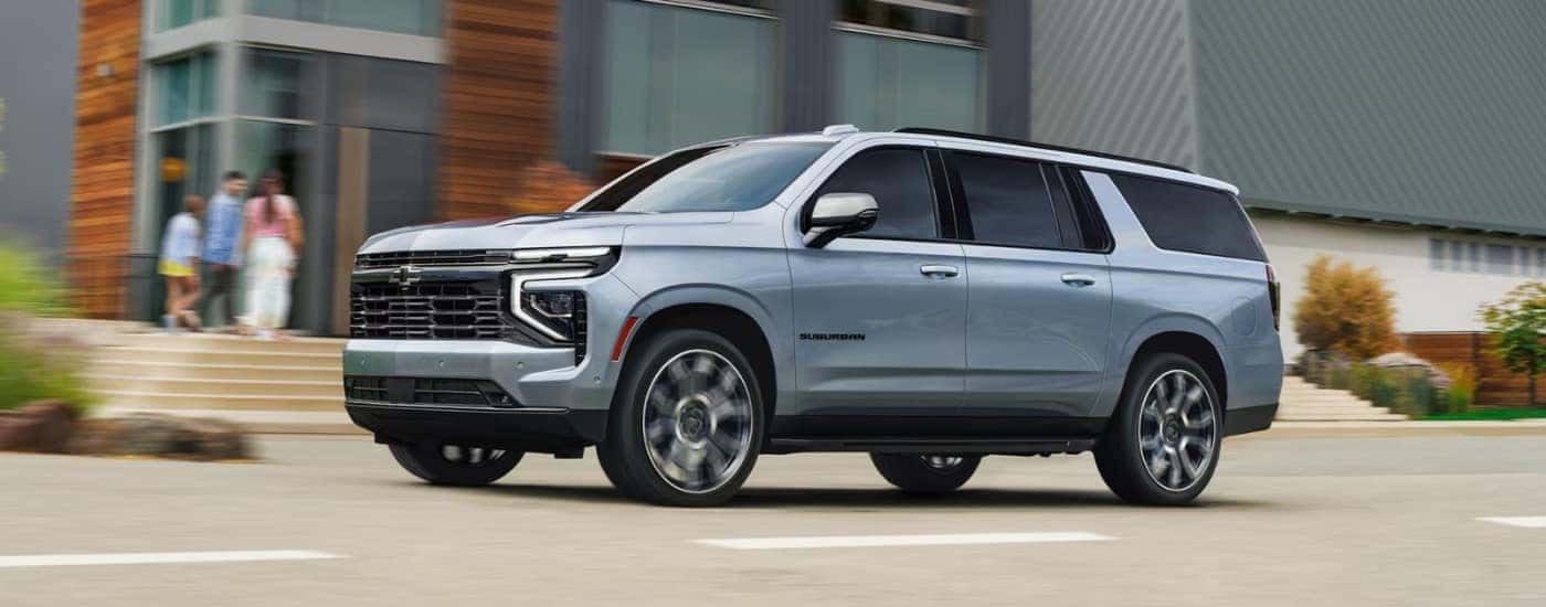 Grey 2026 Chevy Suburban driving on a city street