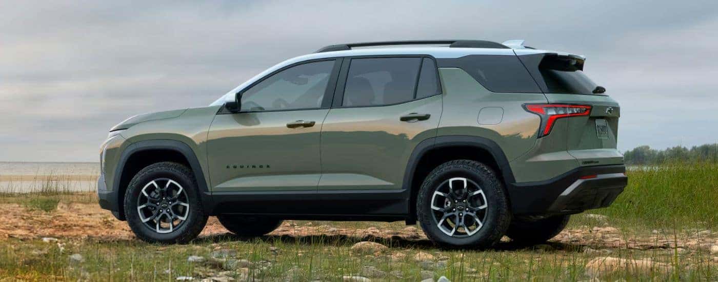 Green 2026 Chevy Equinox parked near the water.