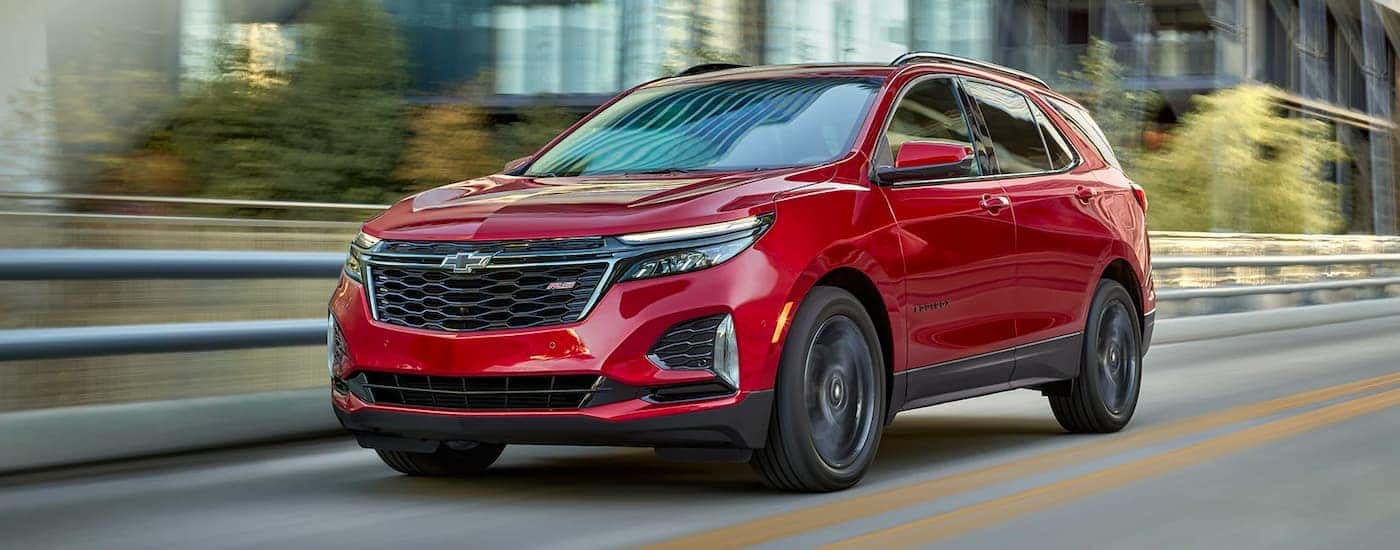 Red 2022 Chevy Equinox RS driving down the road.