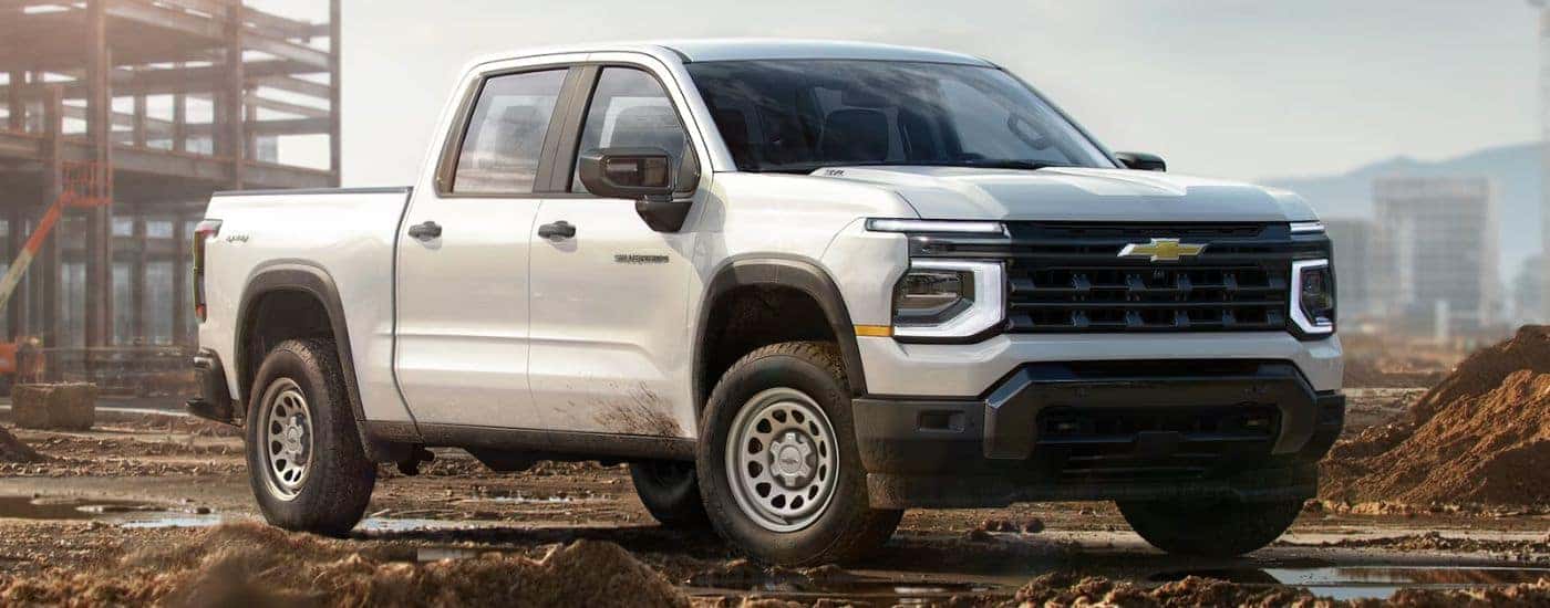 A white 2027 Silverado 1500 parked on a job site.