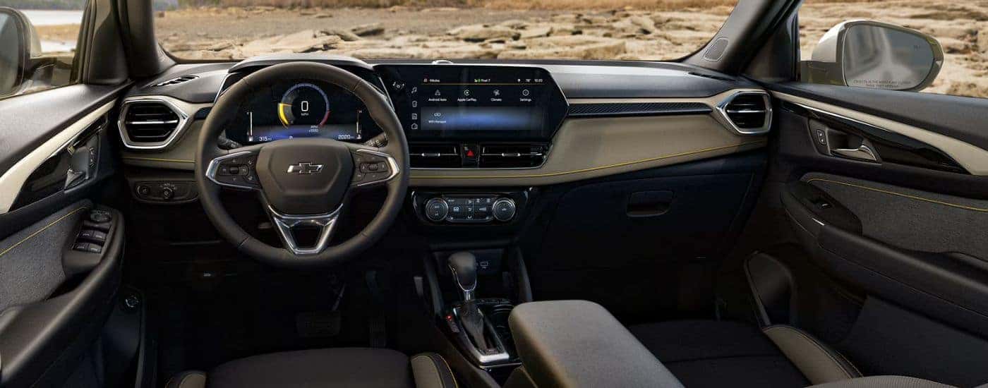 The front interior showing the steering wheel and infotainment display on a 2026 Chevy Trailblazer.