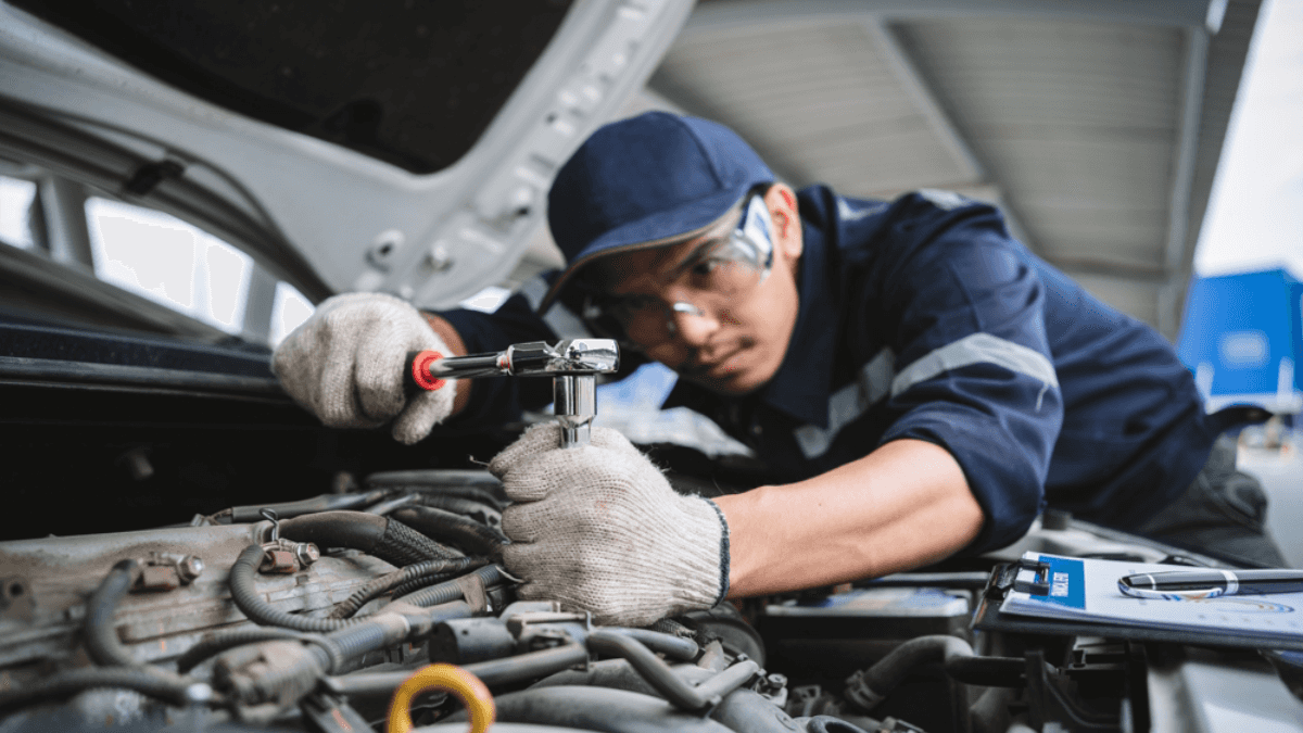 Technician working on a Chevrolet engine