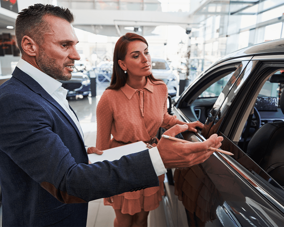 Why drivers should consider an extended warranty on their Chevrolet at Delaney Chevrolet of Greensburg | Sales person showing customer the car options inside of dealership