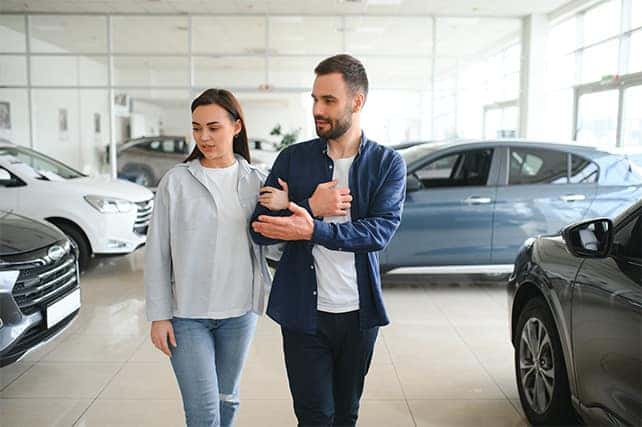 When to Trade In Your Car | Delaney Chevrolet of Greensburg in Greensburg, PA | Couple walking around the dealership together