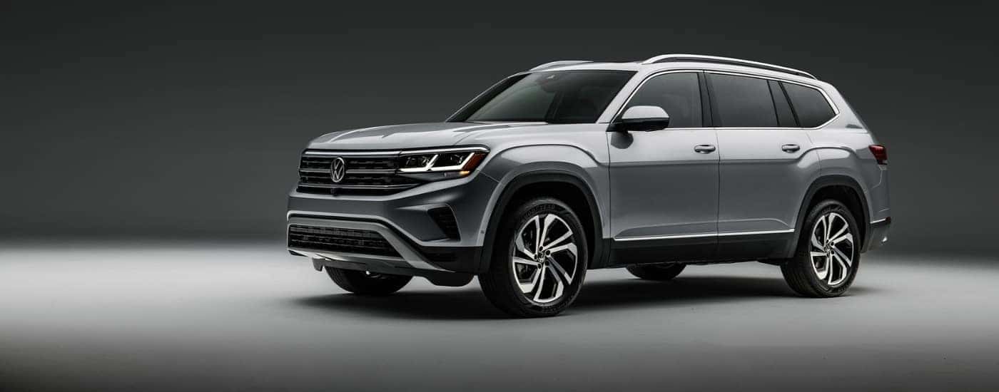 A silver 2021 Volkswagen Atlas against a grey background.