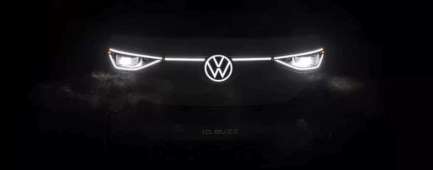 Illuminated headlights and badge on a 2025 Volkswagen ID.Buzz.