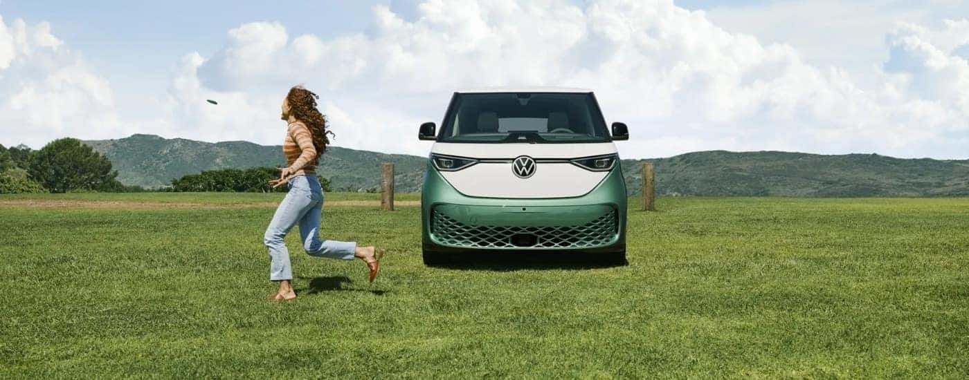 A green 2025 Volkswagen ID. Buzz for sale parked on a field.