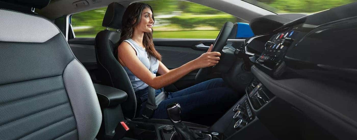 A person driving a 2024 Volkswagen Taos for sale.
