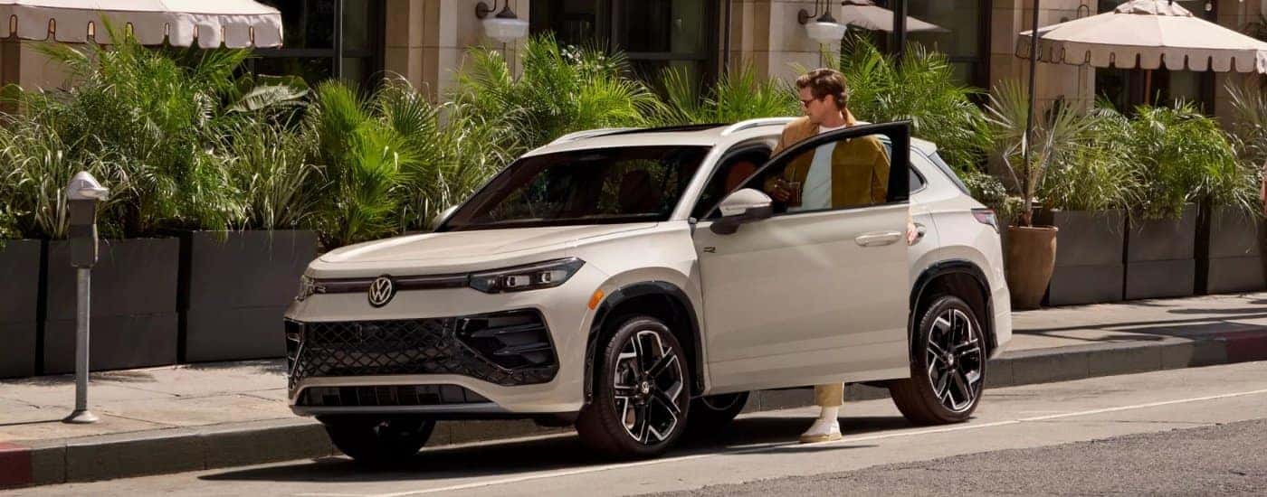A white 2025 Volkswagen Tiguan from the side after leaving a Volkswagen dealer near Palatine.