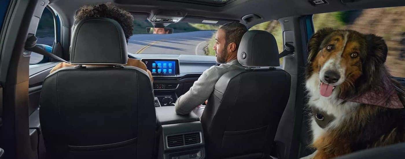 A family and dog riding in a 2024 Volkswagon Atlas Cross Sport