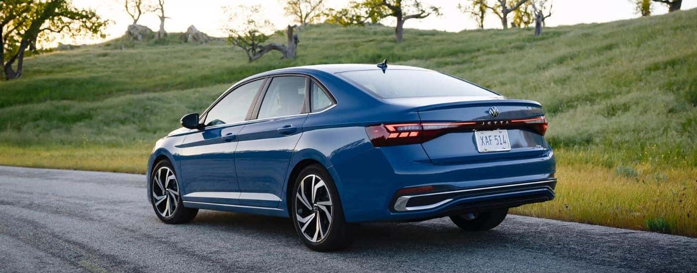 A blue 2026 Volkswagen Jetta from the rear at angle.
