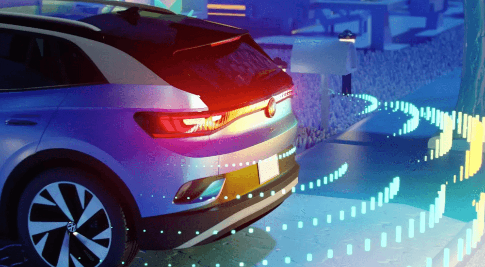 Rear view of an ID.4 backing up out of a driveway. highlighting the technology that comes equipped in 2026 Volkswagens 