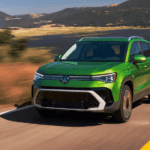 Green 2026 Volkswagen Taos driving to a Volkswagen dealer near Carpentersville