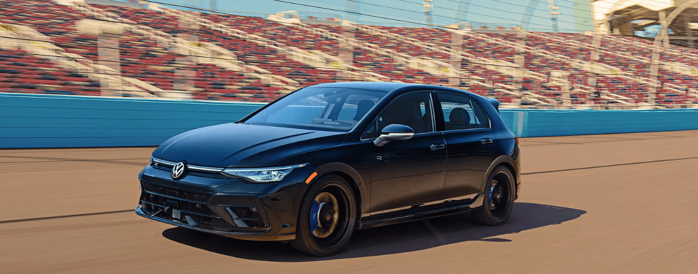 Black 2026 Volkswagen Golf R driving around a track