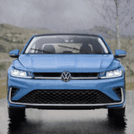 Blue 2026 Volkswagen Jetta driving in the rain