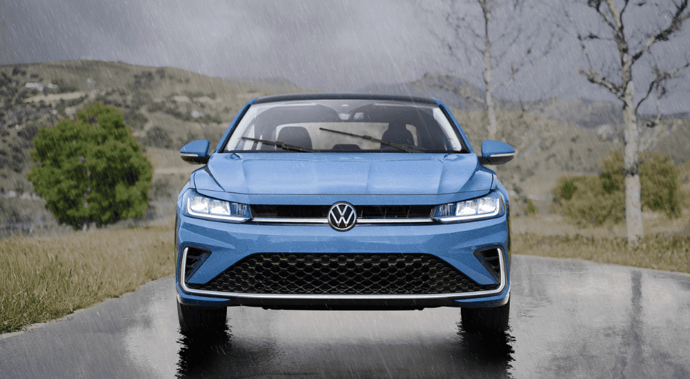 Blue 2026 Volkswagen Jetta driving in the rain