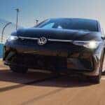 Black 2026 Volkswagen Golf R driving on a racetrack