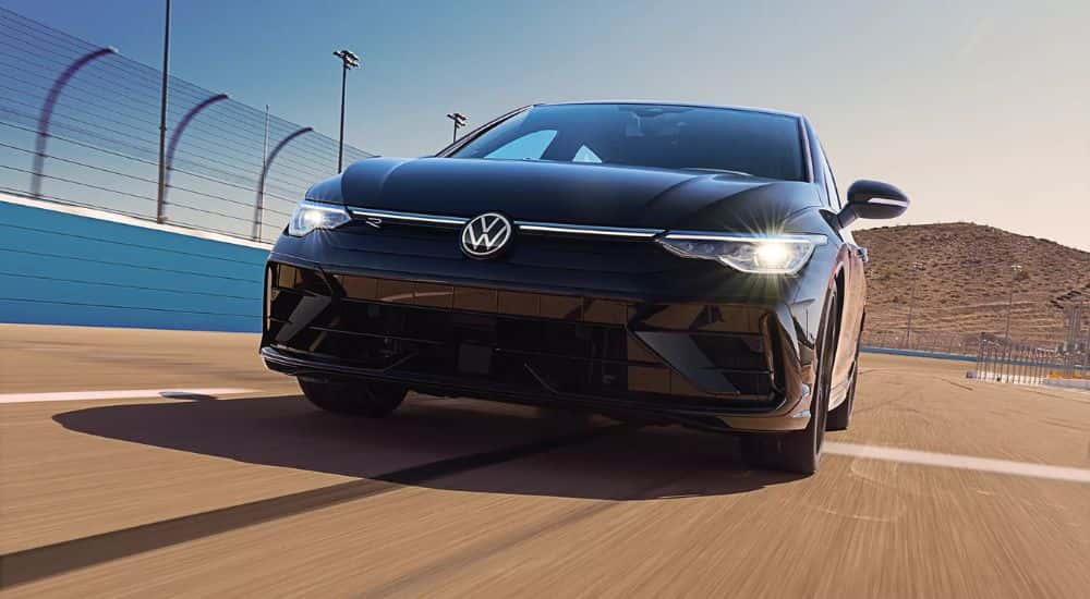 Black 2026 Volkswagen Golf R driving on a racetrack