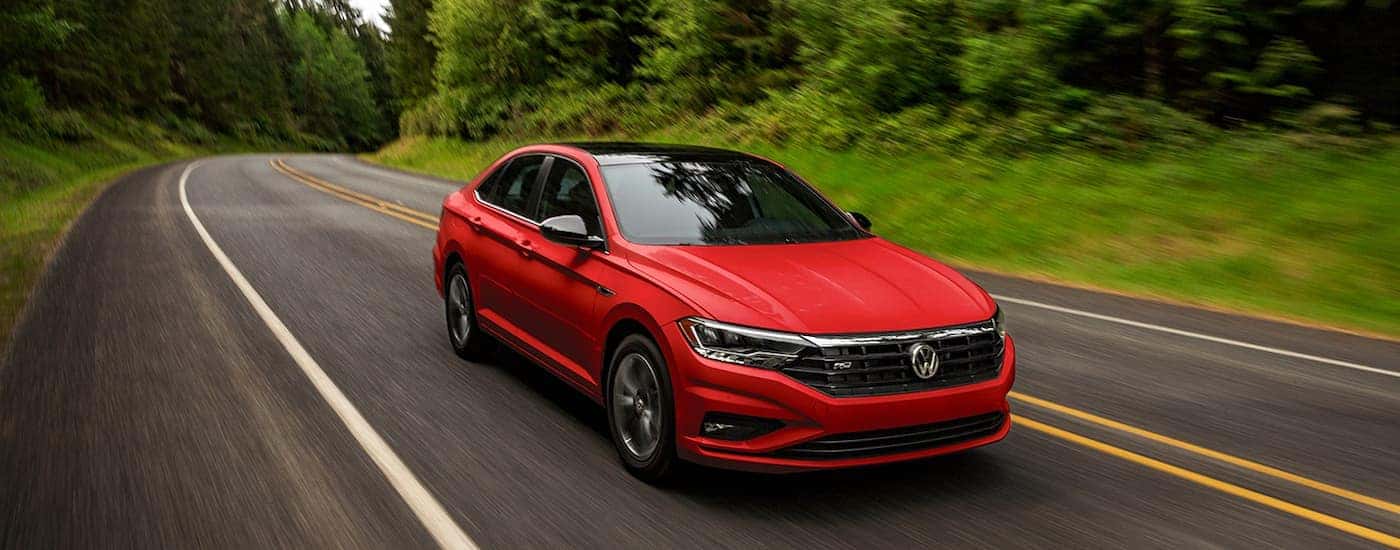 A red 2022 Volkswagen Jetta driving down the road.