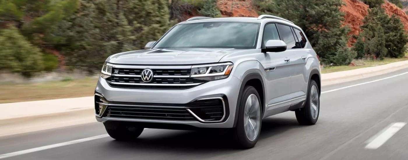 A silver 2023 Volkswagen Atlas R-Line driving.