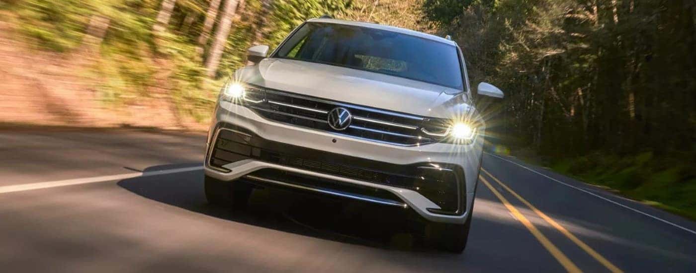 A white 2023 Volkswagen Tiguan shown driving head-on.