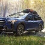 2025 Subaru Outback SUV parked in a forest