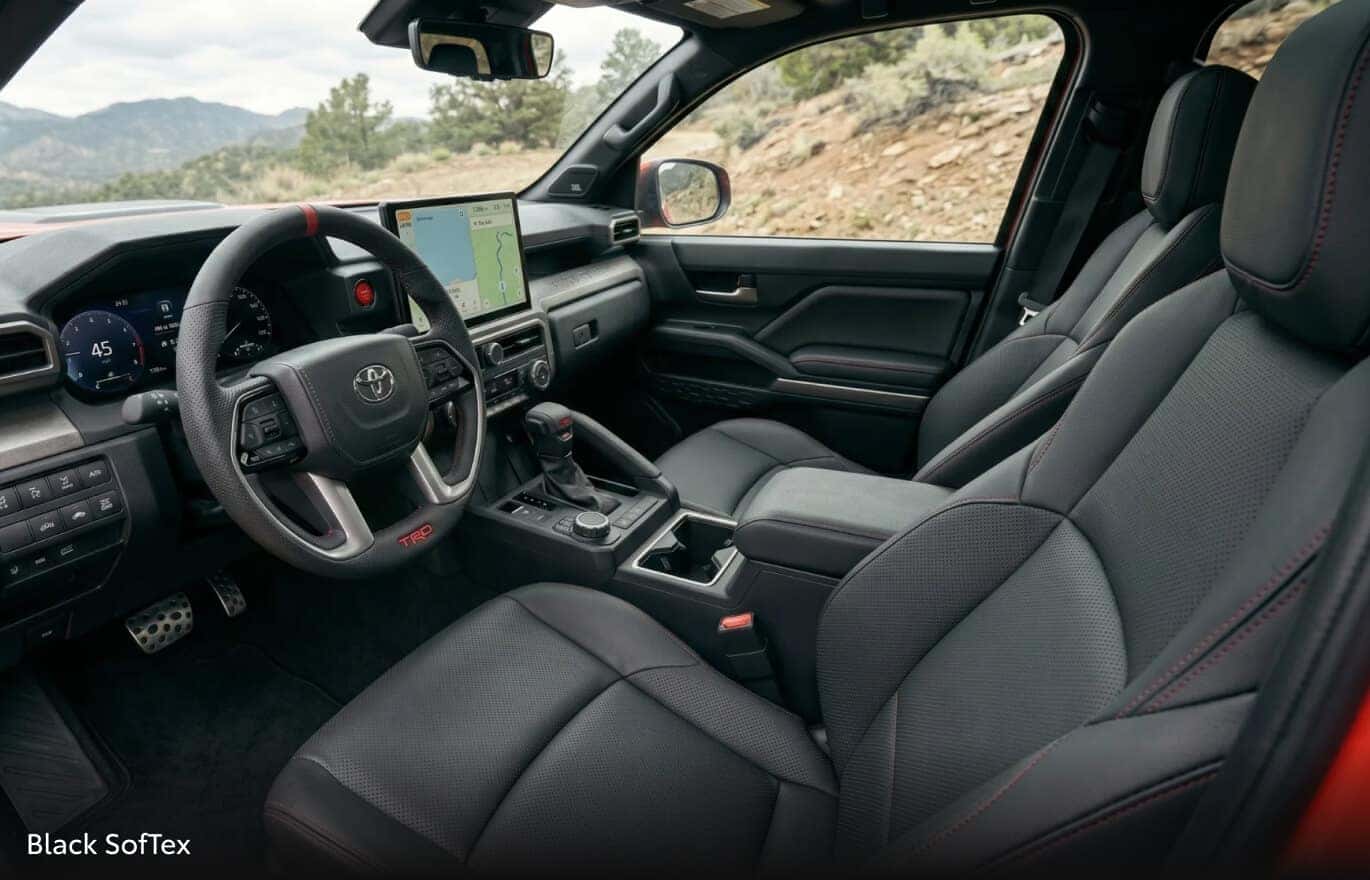 Close-up shot of Tacoma interior from outside driver's door perspective showing Black SofTex upholserty.
