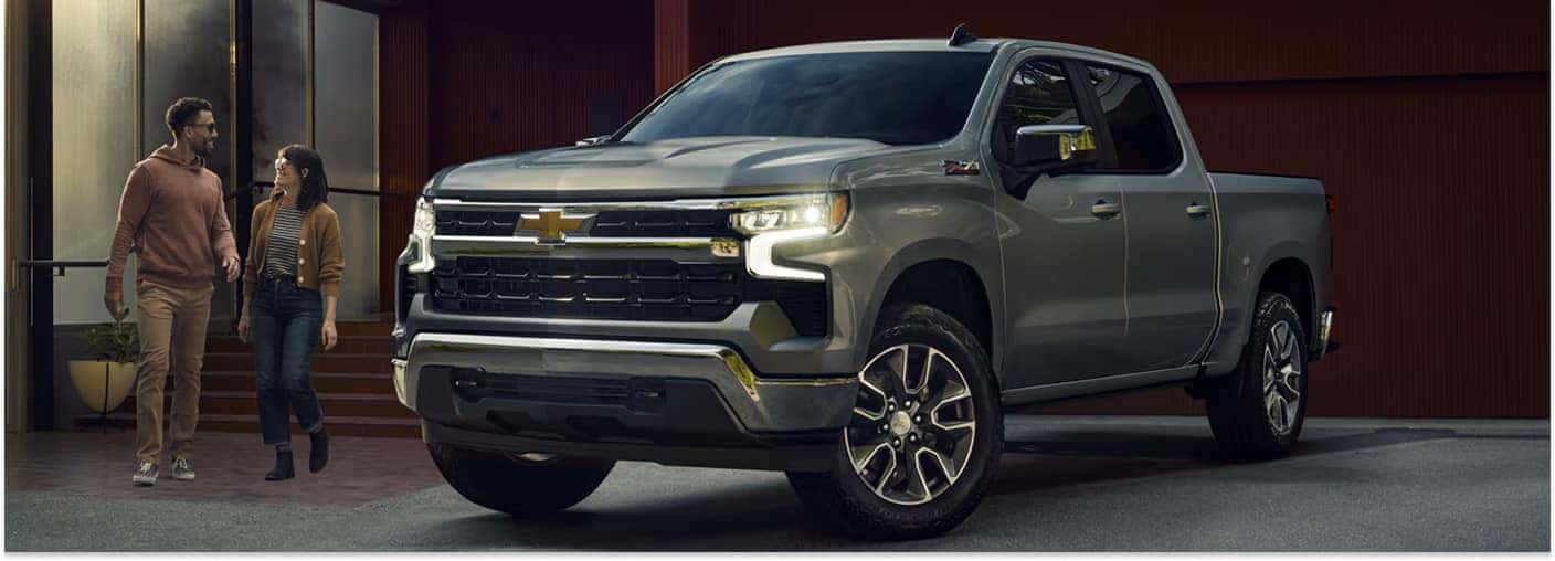 Front three-quarter view of a grey 2026 Chevrolet Silverado 1500 parked outside a building.