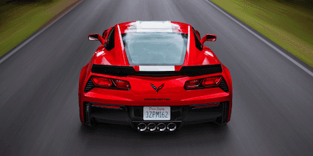 An exterior shot of three cars