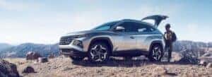 Woman getting hiking gear out of a new Hyundai Tuscon