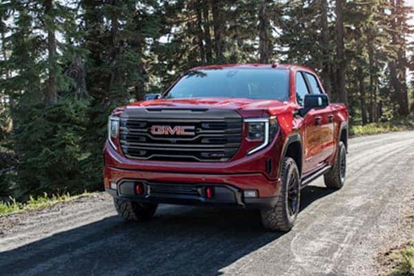 Basic Car Maintenance and Servicing Checklist | Jack Giambalvo Buick GMC | The 2022 GMC Sierra 1500 Seen Driving up a Backroad with a Treeline in the Background