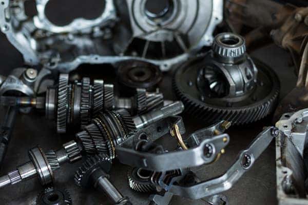 Basic Car Maintenance and Servicing Checklist | Jack Giambalvo Buick GMC | Collection of Spare Car Parts on a Work Bench