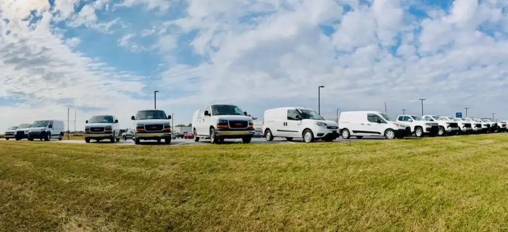 row of cargo vans outside of jack schmitt chevy